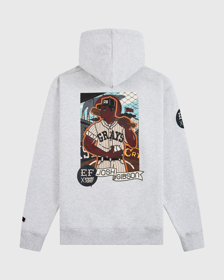 The Ebbets Field Karabo Poppy x Josh Gibson Heavyweight Cotton Pullover Hoodie features a light gray design with an illustrated Josh Gibson in pinstripes, team logos on the sleeves, and vibrant “Josh Gibson” text.