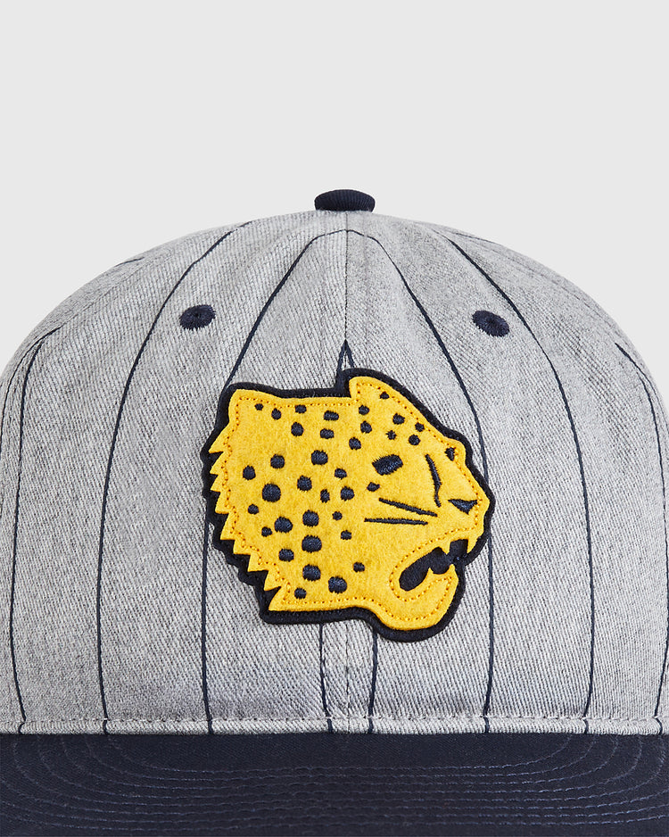 The Ebbets Field Santa Clara Leopardos 1925 Cotton Twill Ballcap features gray and navy stripes with a yellow embroidered jaguar head patch on the front, inspired by the historic Cuban baseball team.