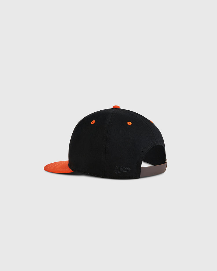 The Ebbets Field Marianao Tigres Cotton Twill Ballcap features a black crown, orange brim and button, adjustable brown strap, top eyelets, and is shown from the back on a plain white background.