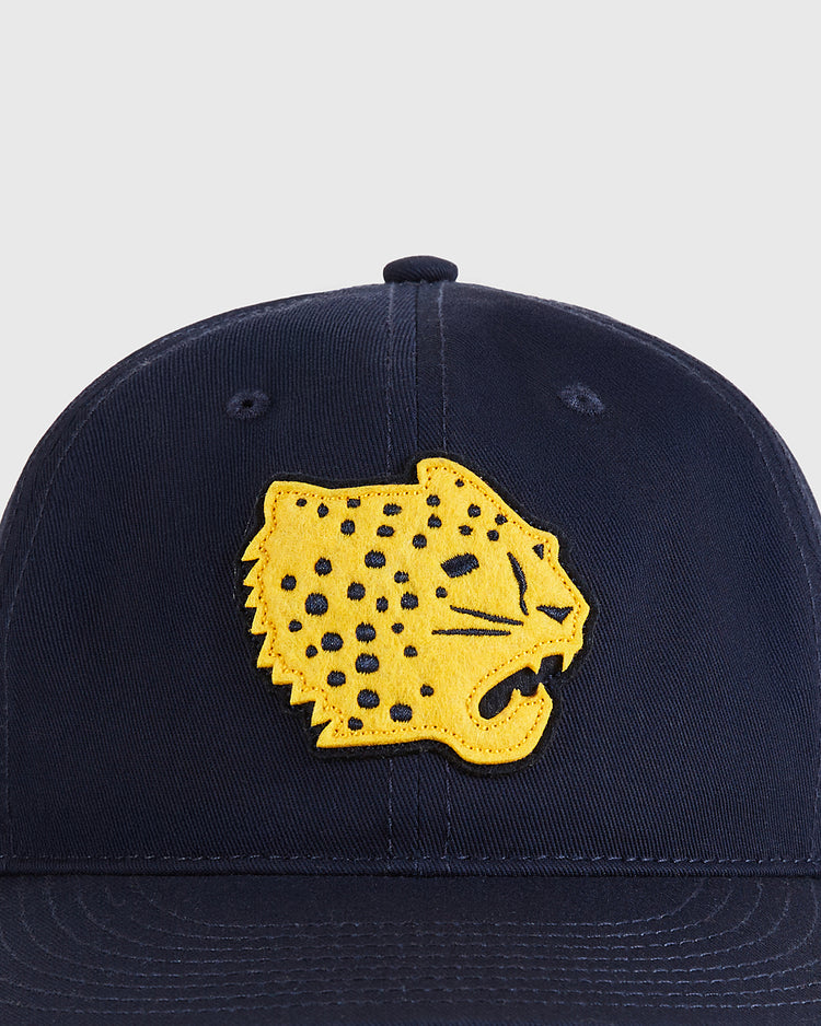 The Ebbets Field Santa Clara Leopardos 1925 Cotton Twill Ballcap is navy blue with a yellow embroidered roaring jaguar head patch with black spots on the front.