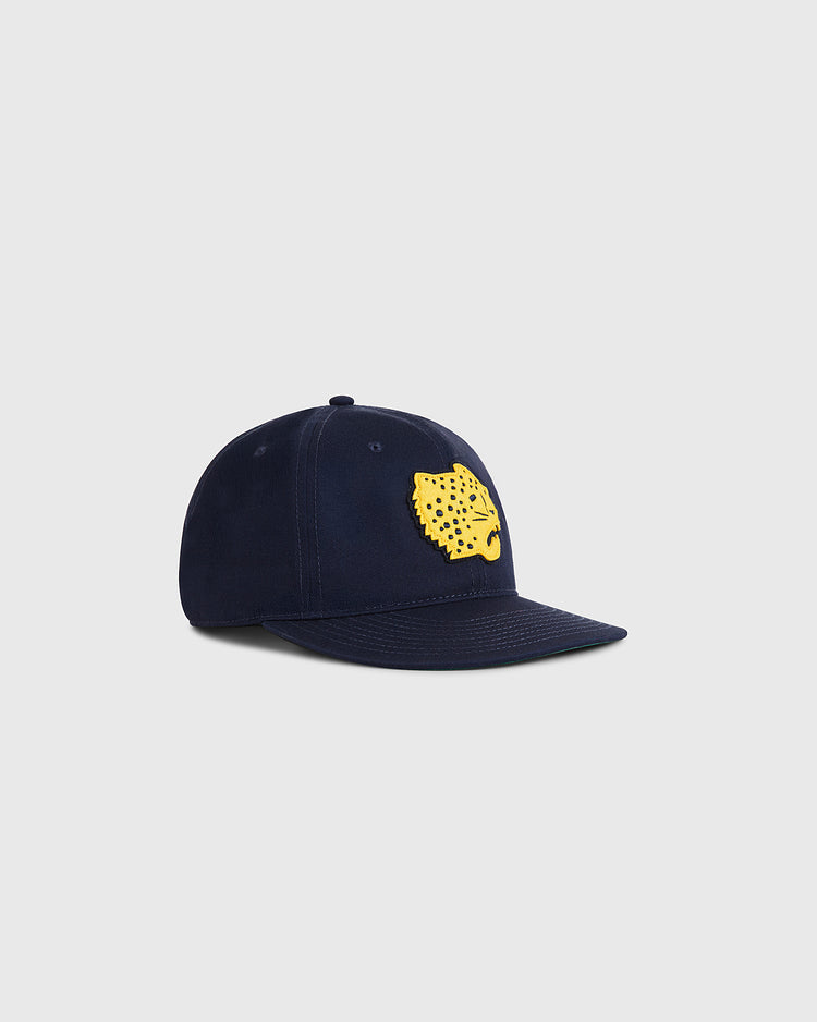 The Ebbets Field Santa Clara Leopardos 1925 Cotton Twill Ballcap features a navy blue design with a yellow jaguar head logo, inspired by classic Cuban baseball hats, shown on a light gray background.