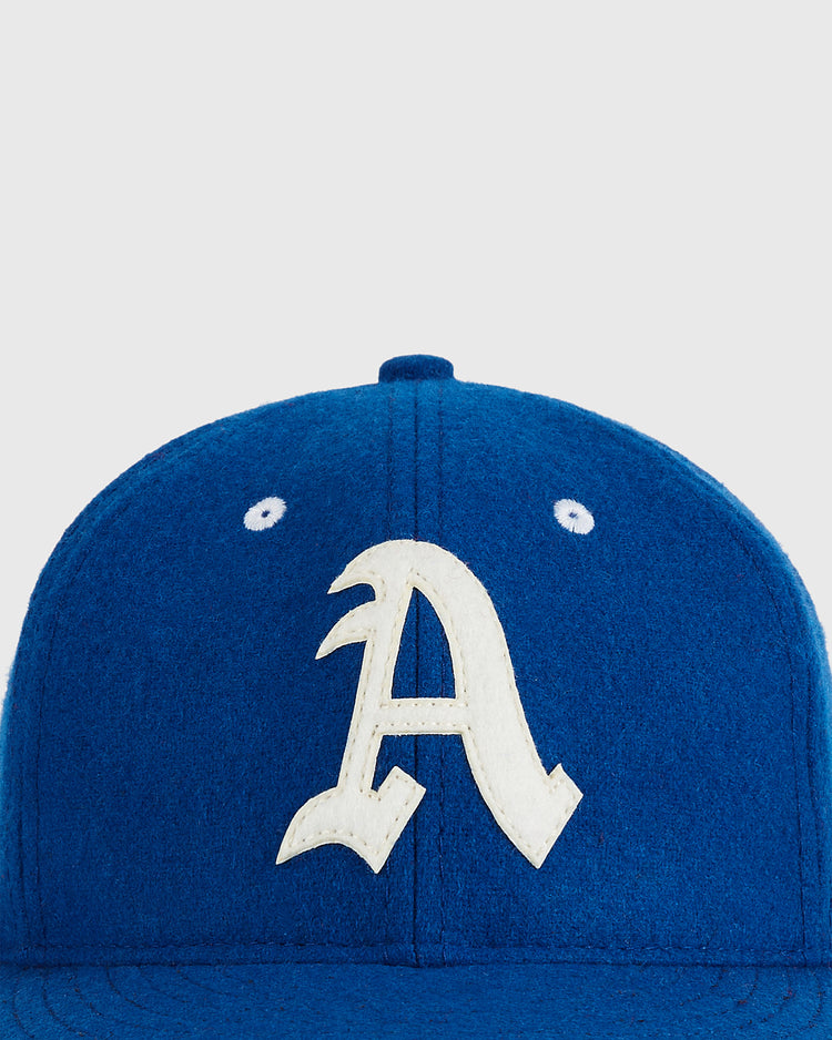 A close-up of the Ebbets Field Almendares Alacranes 1947 Authentic Wool Ballcap shows its blue vintage design with a large white 