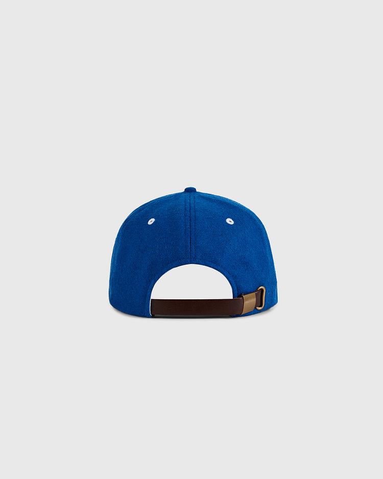 The Ebbets Field Almendares Alacranes 1947 Authentic Wool Ballcap is shown from the back in royal blue, with an adjustable brown strap, metal buckle, and two white embroidered eyelets per side. Light gray background. Cuban baseball-inspired.