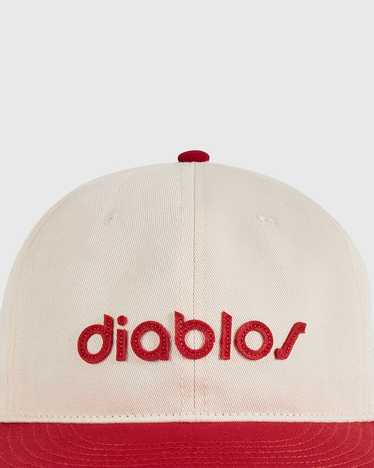 The Diablos Rojos del Mexico Cotton Twill Ballcap by Ebbets Field features a cream color with a red brim and 