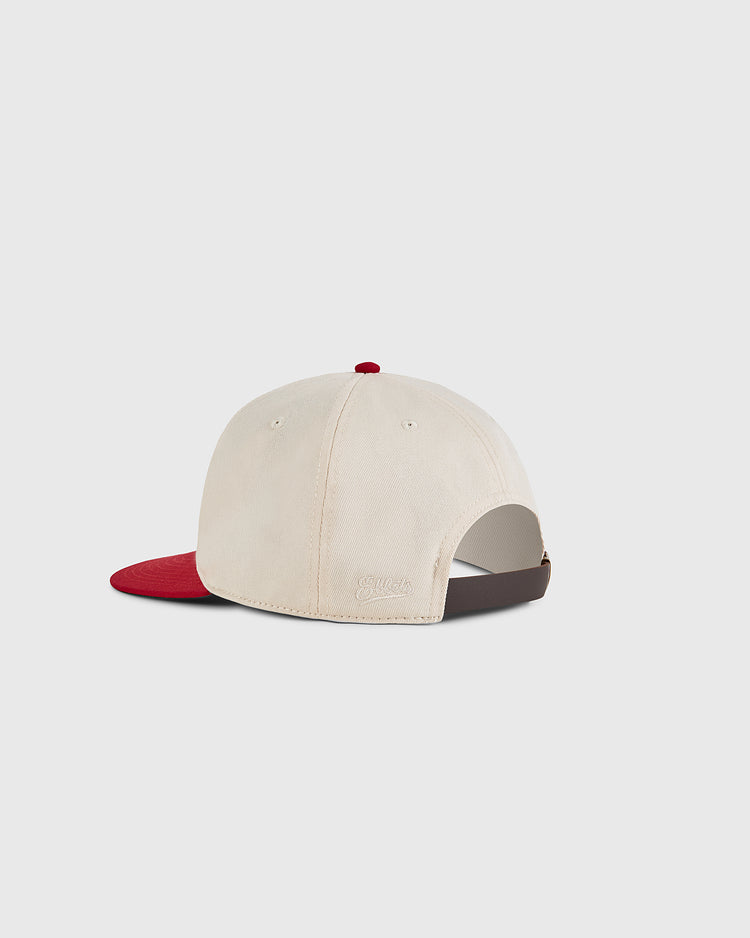 The Ebbets Field Diablos Rojos del Mexico Cotton Twill Ballcap features a beige crown, red visor, adjustable brown strap, and a red top button—classic details inspired by Mexican baseball caps, shown here from the back.