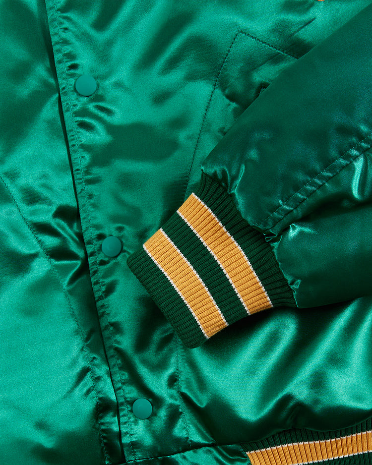 Close-up of the Ebbets Field Notre Dame Satin Varsity Jacket, featuring shiny green satin, green buttons, and a ribbed cuff with green, yellow, and white stripes.
