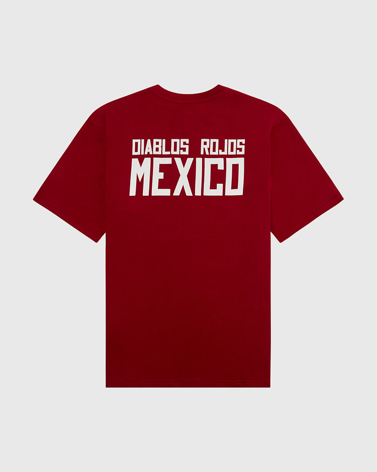 The Ebbets Field Diablos Rojos del Mexico Short Sleeve Graphic Tee features bold white DIABLOS ROJOS MEXICO text on the back, honoring the iconic Liga Mexicana de Beisbol team, shown against a plain light gray background.