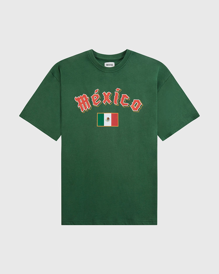 The Ebbets Field Mexico National Team Short Sleeve Graphic Tee is a green vintage shirt with “México” in white and red letters above the Mexican flag on the chest, inspired by the national baseball team and shown against a plain white background.