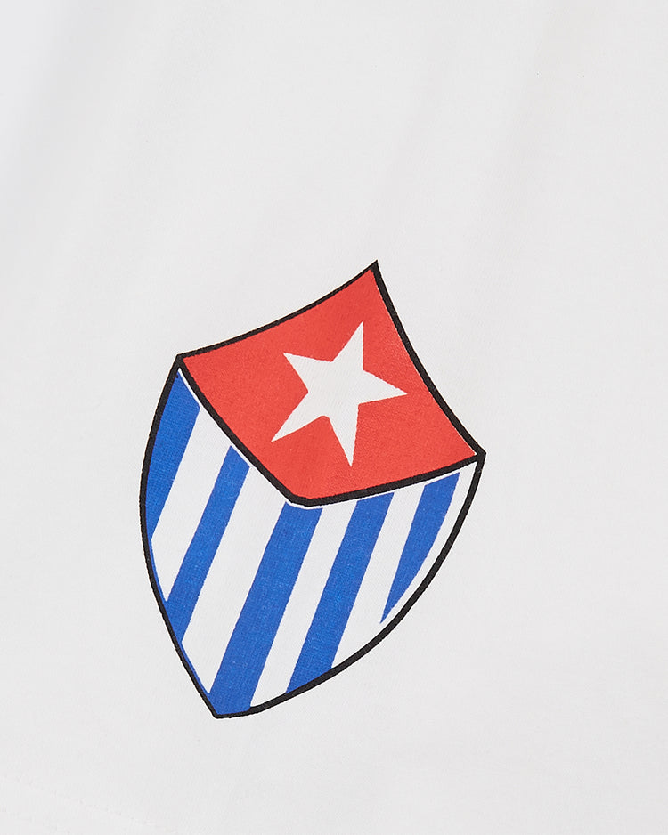 The Marianao Tigres Short Sleeve Graphic Tee by Ebbets Field features a shield emblem with a red top and white star, blue and white stripes below, inspired by classic Cuban League designs on a plain white background.