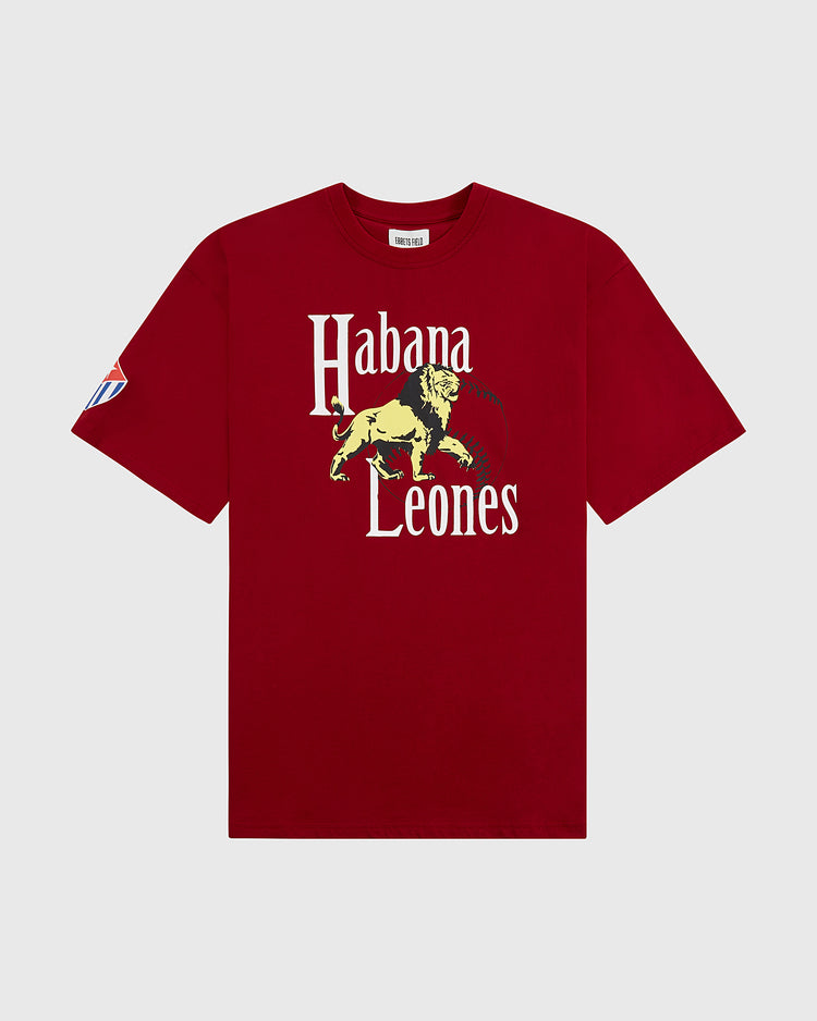 The Ebbets Field Habana Leones Short Sleeve Graphic Tee – Cuban League is a red shirt with white “Habana Leones” text, a yellow lion graphic on the front, and a blue, white, and red patch on the left sleeve honoring the Cuban League team.