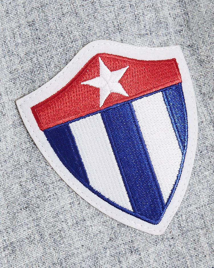 A shield patch inspired by a 1947 design, with red, white star, and blue-and-white stripes, is ideal for customizing your EFF Cuba National Team 1947 Authentic Wool Road Baseball Jersey.