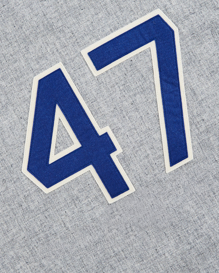 Large blue and white 47s are sewn onto gray textured wool, evoking the iconic look of the Cuba National Team 1947 Authentic Wool Road Baseball Jersey by EFF, with numbers angled diagonally for vintage style.
