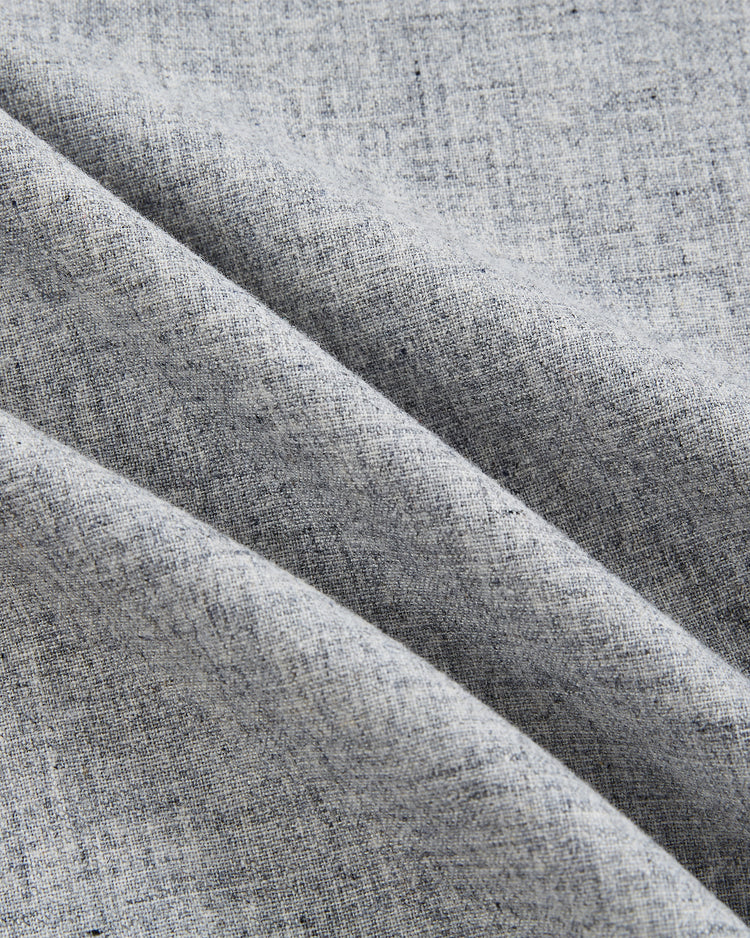 Close-up of light gray wool fabric from the EFF Cuba National Team 1947 Authentic Road Baseball Jersey, featuring a subtle woven texture and three gentle diagonal folds with soft shadows and highlights.
