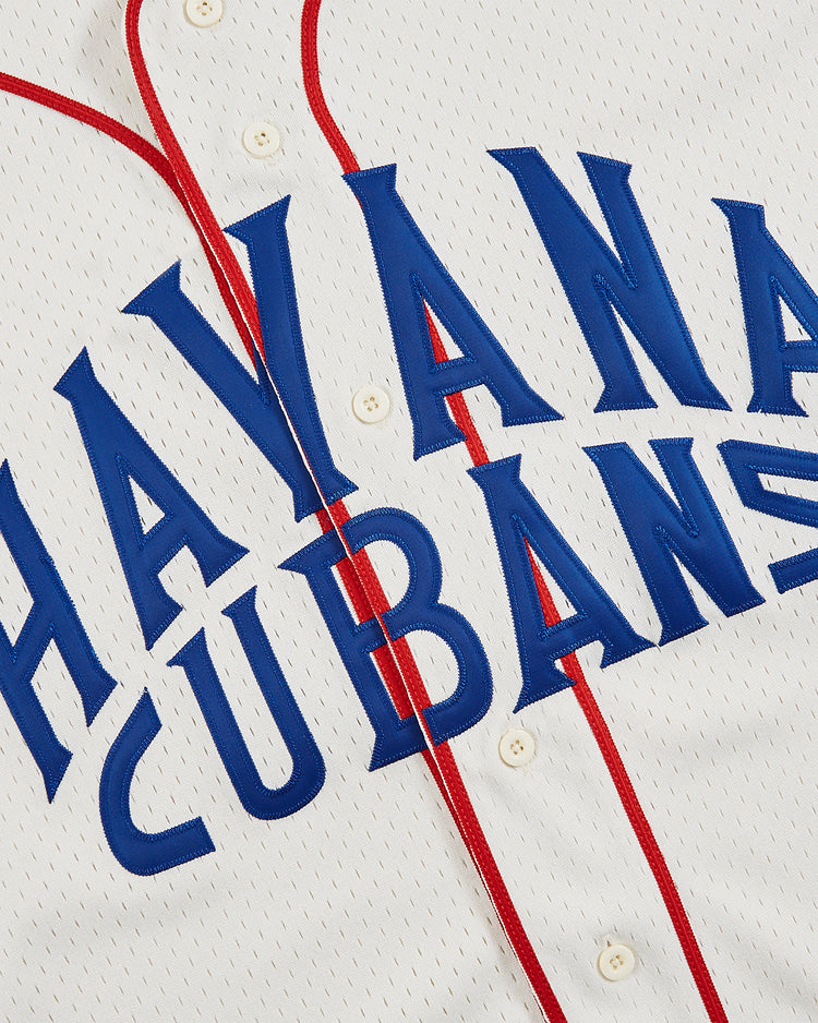 Close-up of the Ebbets Field Havana Cubans Mesh Button-Up Jersey, showcasing blue HAVANA CUBANS lettering and red piping along the buttons—an homage to this classic minor league team.