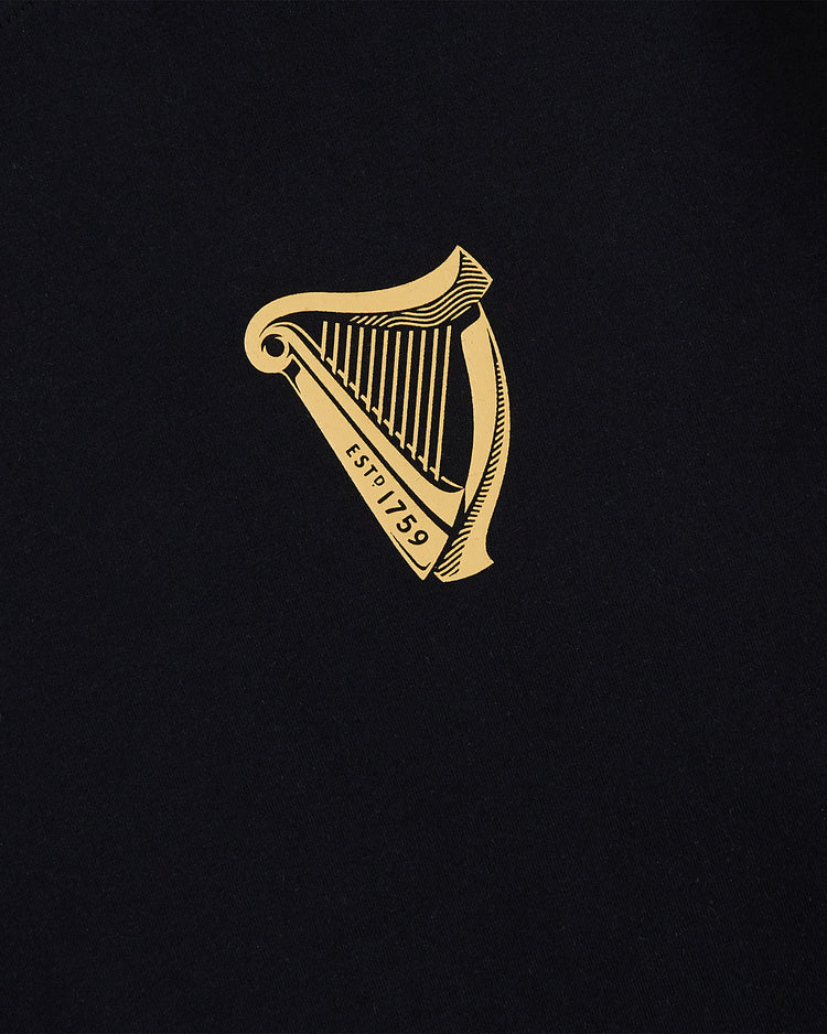 The Ebbets Field Guinness Tortoise Short Sleeve Graphic Tee features a bold graphic on black, delivering classic style.