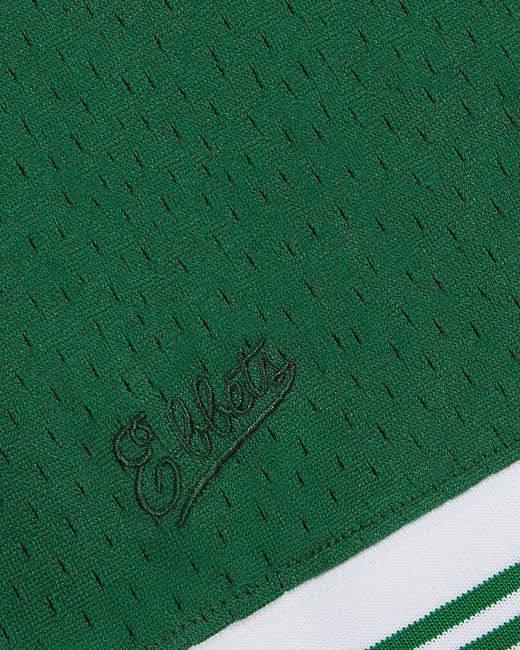 Close-up of a green Guinness Toucan Mesh V-Neck Jersey by Ebbets Field, featuring textured fabric with 