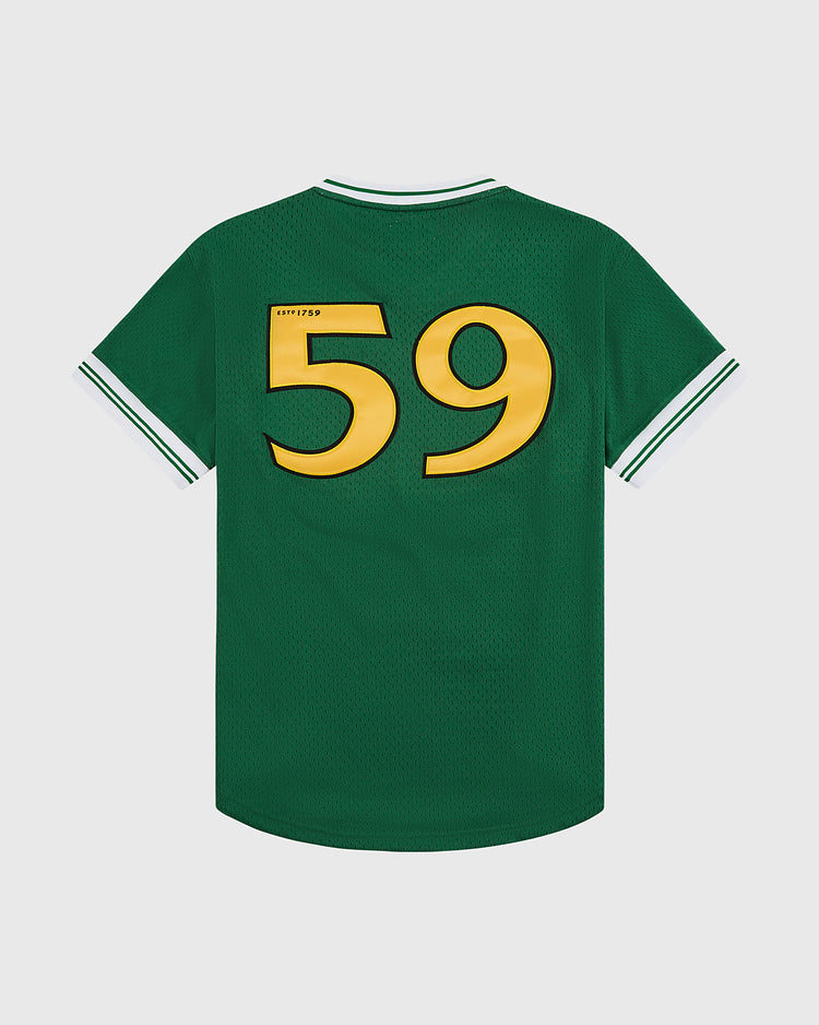 The Ebbets Field Guinness Toucan Mesh V-Neck Jersey is a green sports jersey with white and green striped cuffs and collar, featuring a large yellow number 59 on the back.