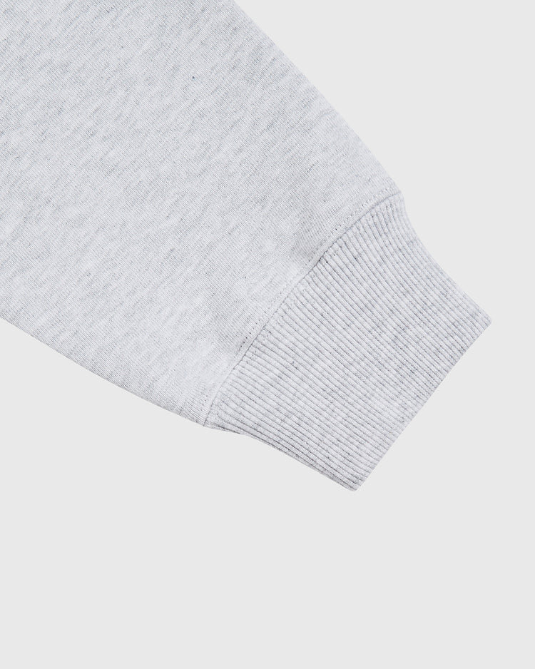 Close-up of the Ebbets Field Guinness Heavyweight Cotton Terry Pullover Hoodie sleeve, highlighting the ribbed cuff and soft fabric texture against a plain white background.
