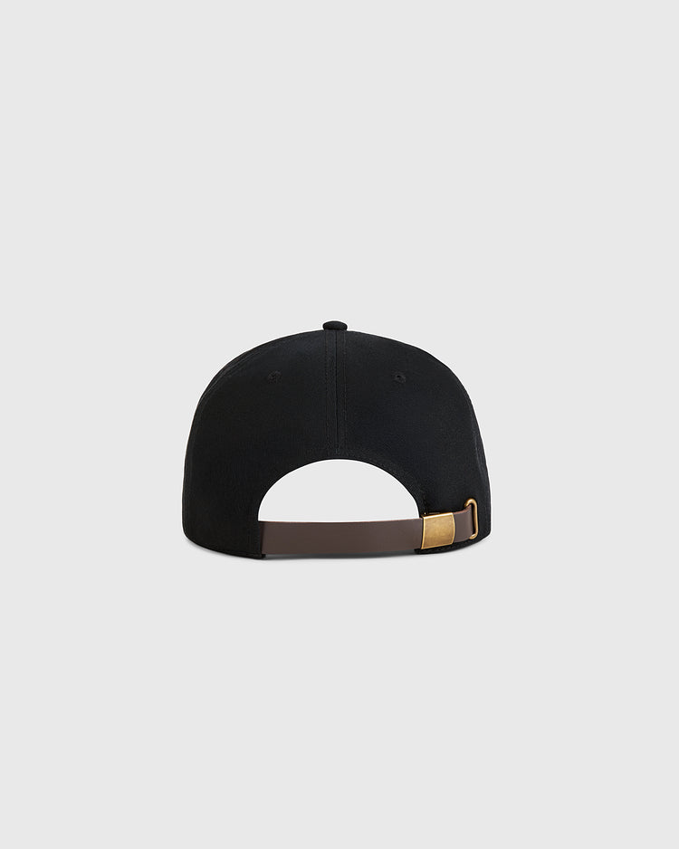 The Guinness Extra Stout Badge Cotton Twill Ballcap by Ebbets Field is shown from the back, featuring a brown adjustable strap with a gold-colored buckle against a plain light gray background.