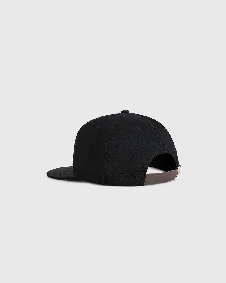 The Guinness Extra Stout Badge Cotton Twill Ballcap by Ebbets Field is shown from the back with an adjustable brown strap and a curved brim, set against a plain light gray background.