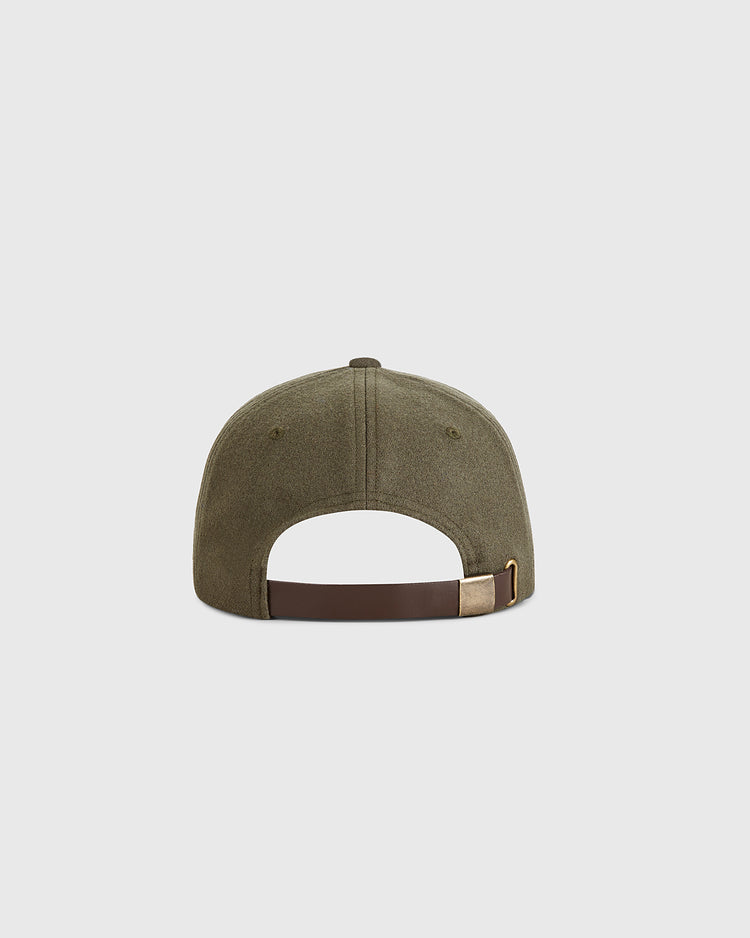 Guinness Seal Authentic Wool Ballcap by Ebbets Field shown from the back, displaying a brown adjustable strap with brass buckle. The cap is olive green and set against a plain light gray background.