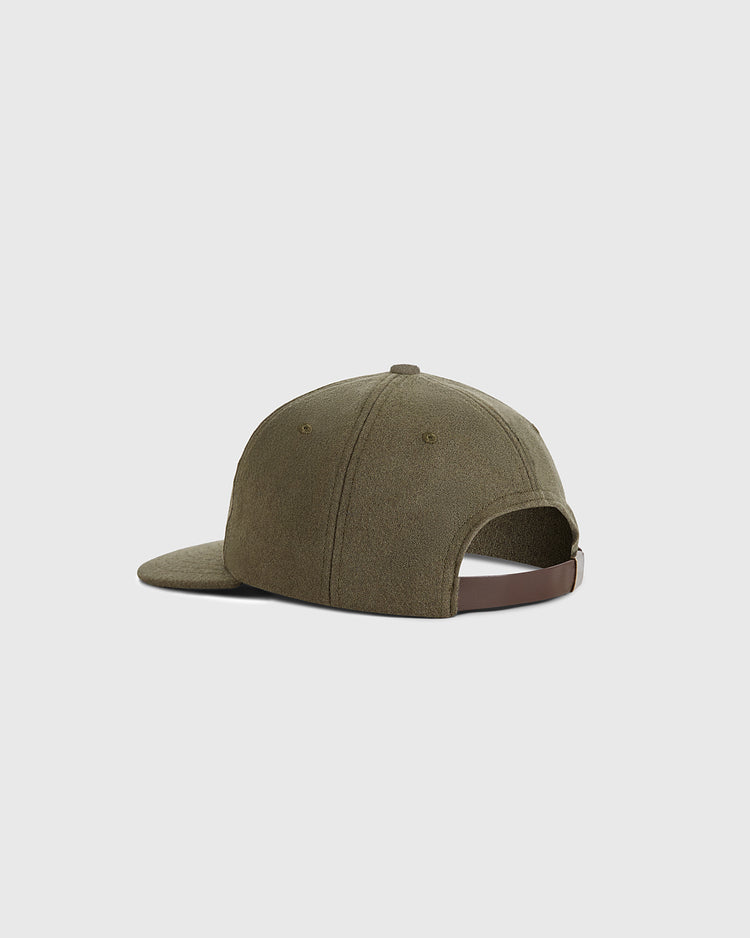 The Ebbets Field Guinness Seal Authentic Wool Ballcap, in olive green textured wool, is shown from the back and side with a curved brim and adjustable brown strap. The cap is set against a plain light gray background.