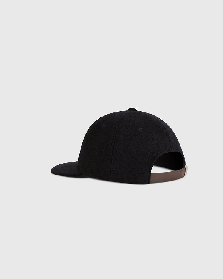 A Guinness Tortoise Authentic Wool Ballcap by Ebbets Field, shown from the back with a curved brim and adjustable brown strap closure, set against a plain light gray background.