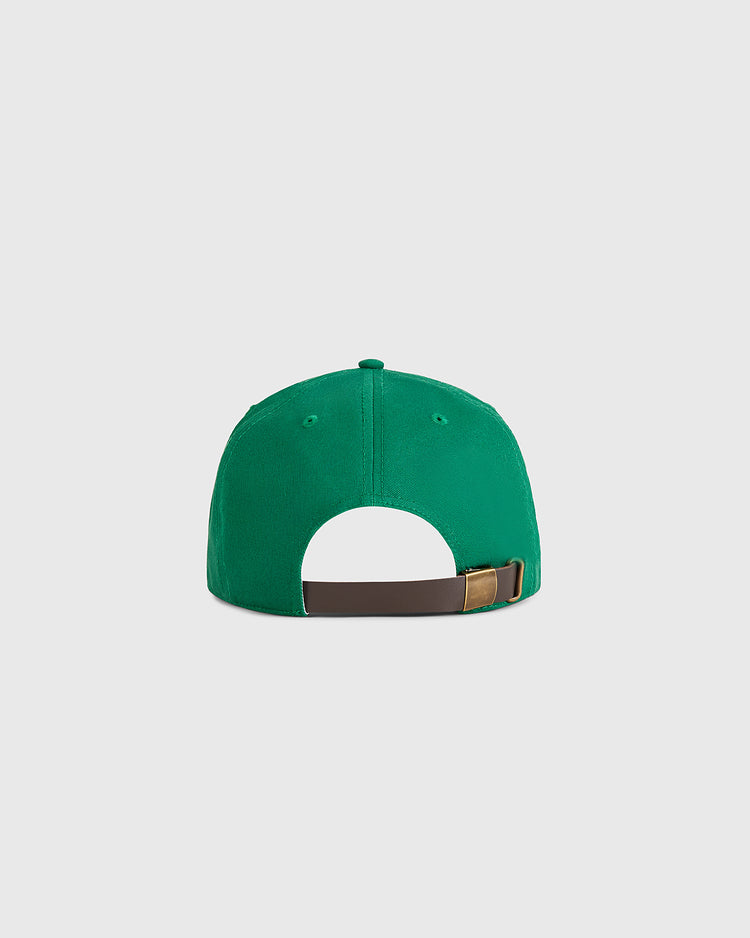 The Ebbets Field Guinness Extra Stout Badge Cotton Twill Ballcap is shown from the back, highlighting its green color, brown adjustable strap with brass buckle, and a plain light background.