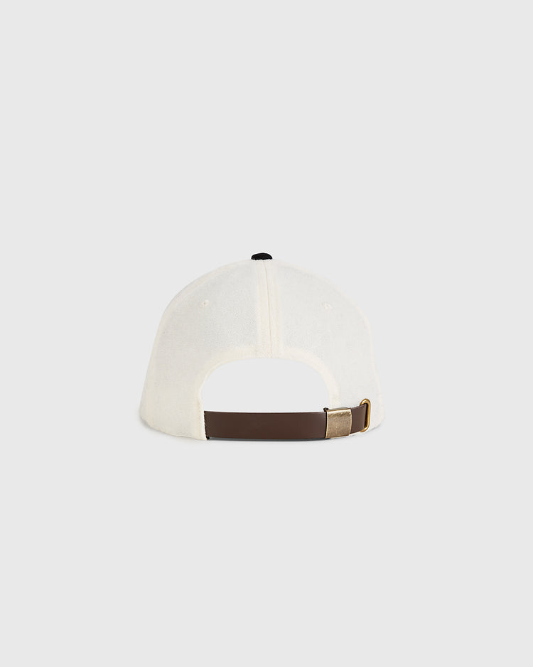 A back view of the Guinness Flying Toucan Authentic Wool Ballcap by Ebbets Field, in white with a brown adjustable strap and gold buckle, shown against a plain light gray background.