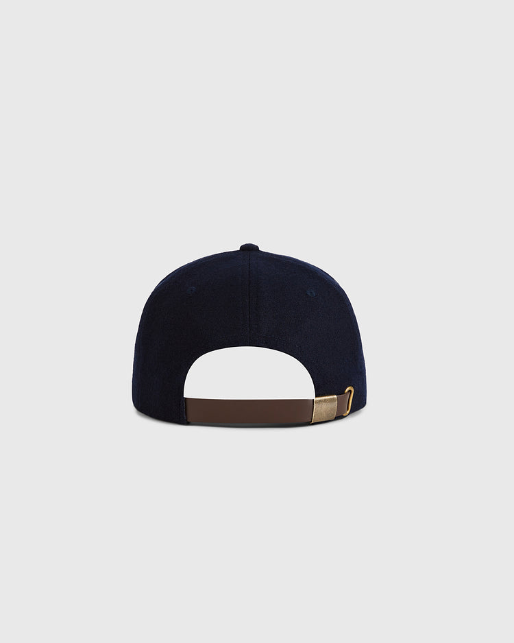 The Guinness Flying Toucan Authentic Wool Ballcap by Ebbets Field is shown from the back with a brown adjustable strap and gold buckle, set against a plain light gray background.