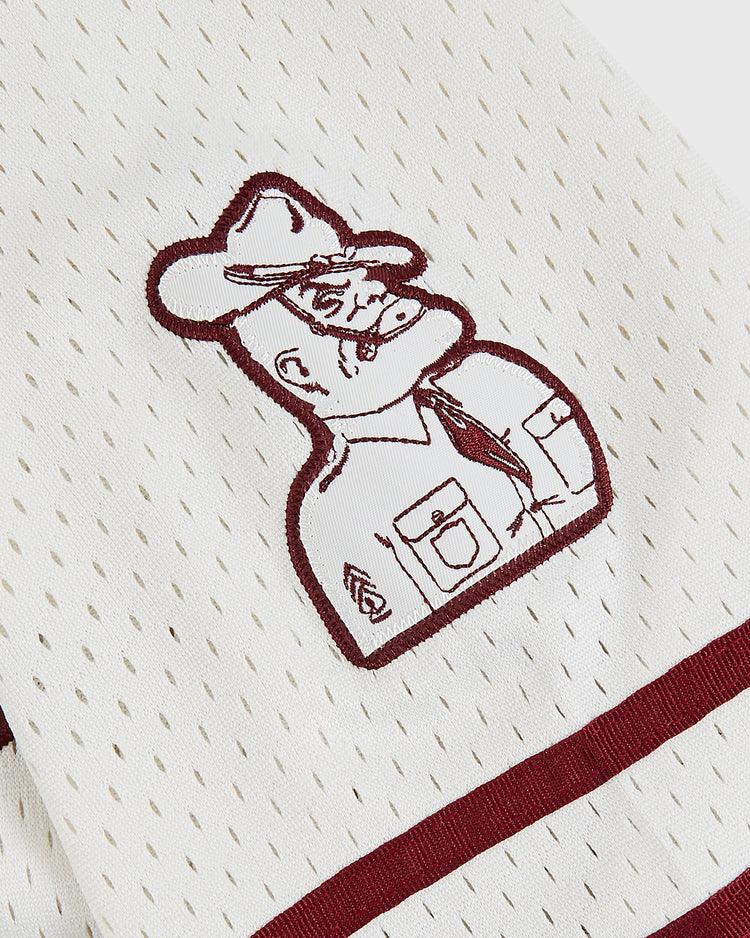 The Ebbets Field Texas A&M University 1952 Button-Up Mesh Jersey features white mesh with maroon trim and an embroidered stern-faced military cartoon, inspired by the classic vintage Aggies baseball style.
