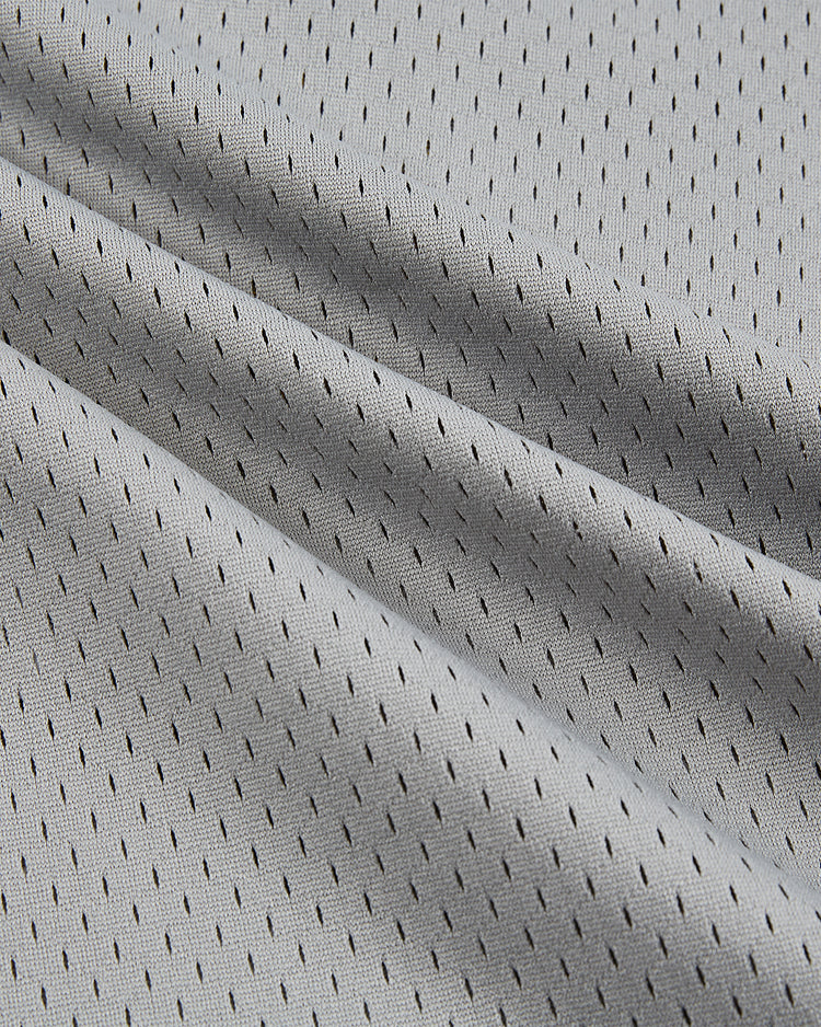 Close-up of the Ebbets Field Louisianna State University 1987 V-Neck Mesh Jersey, light gray with small black vertical dashed lines, soft folds, and a smooth textured surface inspired by the original LSU Tigers design.