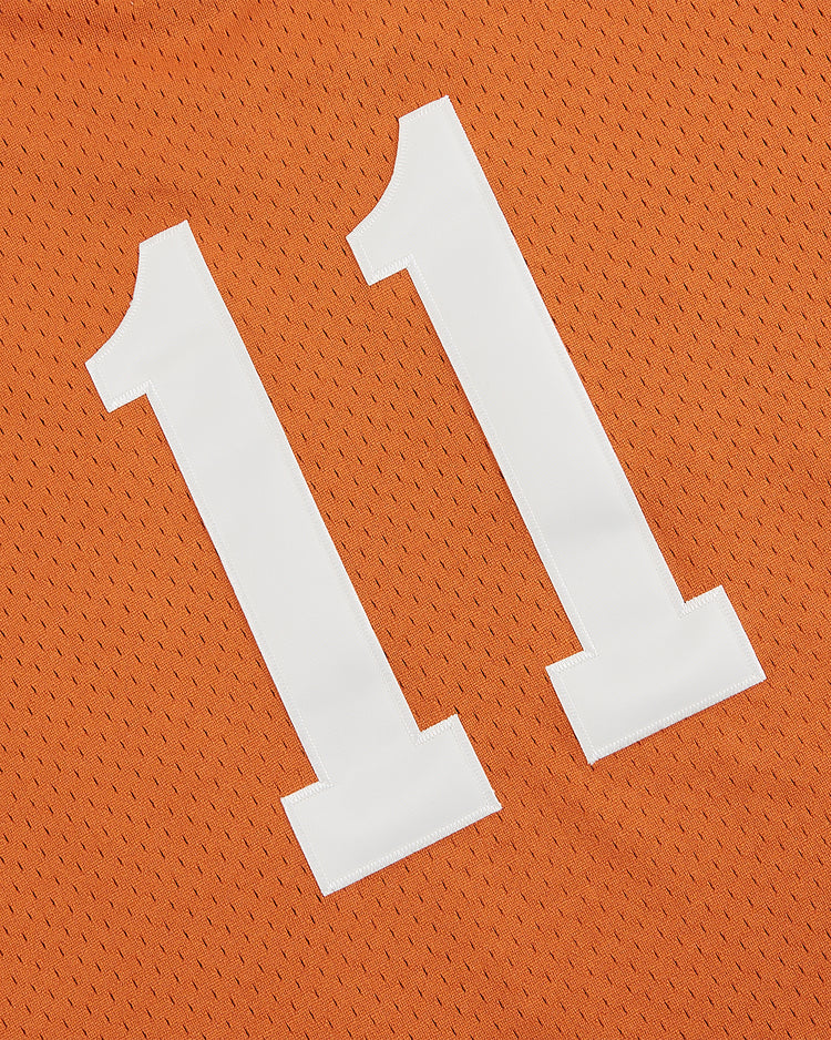 The Ebbets Field University of Texas 1982 V-Neck Mesh Jersey features a white number 11 on orange mesh, inspired by the classic Longhorns jersey from the College World Series.