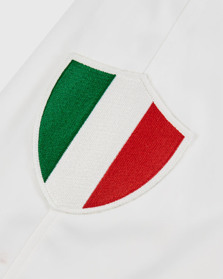 An embroidered shield patch with green, white, and red stripes—representing Italy's flag—is sewn onto a white background on the Diablos Rojos del Mexico Satin Varsity Jacket by Ebbets Field. Perfect for personalizing your look.