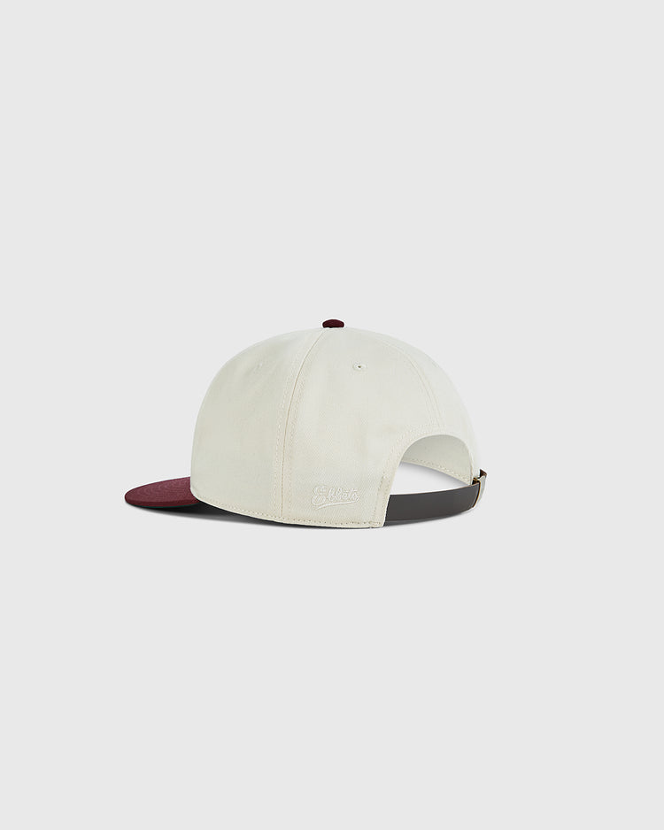 The Ebbets Field Texas A&M University 1952 Cotton Twill Ballcap is cream-colored with a maroon brim, adjustable strap, and small side logo, shown from the back—evoking a classic vintage baseball cap style.