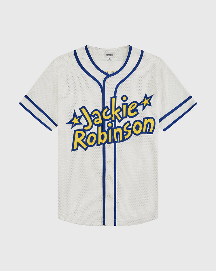 The Ebbets Field Jackie Robinson Comic Book Hero Button-Up Mesh Jersey is a white mesh jersey with blue trim and buttons, featuring bold yellow and blue lettering and stars inspired by comic books.