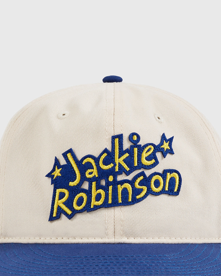 The Ebbets Field Jackie Robinson Comic Book Hero Cotton Twill Ballcap features Jackie’s name embroidered in yellow and blue, decorative stars, a blue brim, and classic comic book style—ideal for history buffs and fans alike.