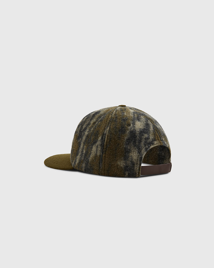 The Ebbets Field Mossy Oak x 1966 University of Notre Dame Ballcap features a green and brown tie-dye camo pattern, a curved brim, and an adjustable strap with metal buckle at the back. Shown from the rear.