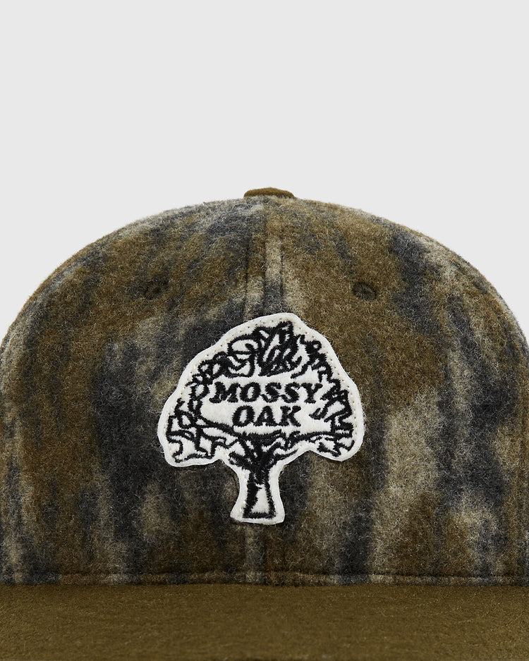 Close-up of the Mossy Oak x Ebbets Field Vintage Tree Logo Ballcap by Ebbets Field, featuring a tree-shaped white patch with 