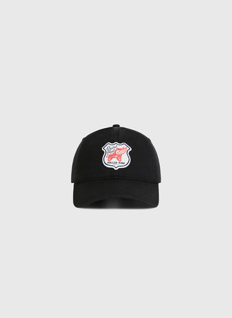 The Ebbets Field Seattle Crystal Pool Roller Rink Washed Cotton Ballcap is a black vintage-style cap with a white patch featuring red text and design, inspired by Seattle’s Crystal Pool roller rink, shown on a plain light gray background.