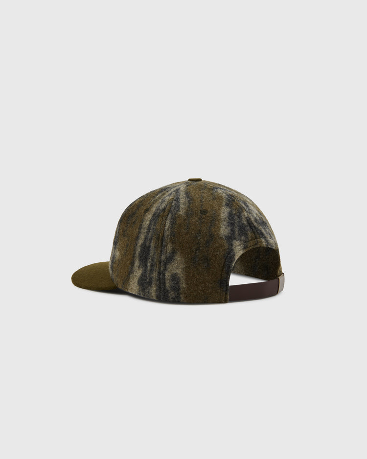 A back view of the Ebbets Field Mossy Oak x 1956 USA National Team Ballcap, featuring a curved brim and adjustable brown strap, shown in Mossy Oak Bottomland Camo against a plain light gray background.