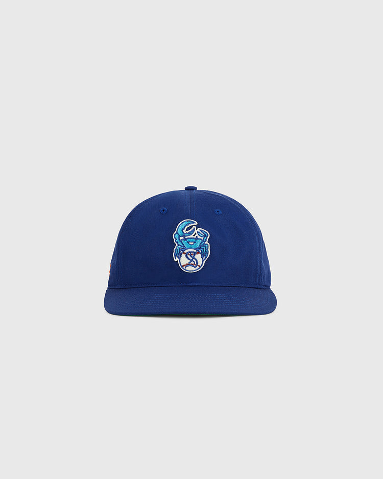 The Ebbets Field Santurce Cangrejeros Crab Cotton Twill Ballcap is royal blue with a flat brim and features an embroidered crab mascot, displayed against a plain light gray background.