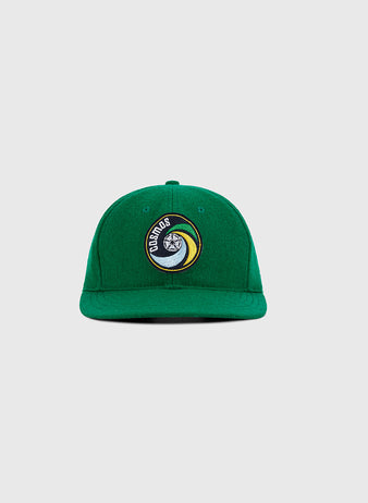 The Ebbets Field New York Cosmos Wool Ballcap features green wool, a front circular patch with a yin-yang face and 