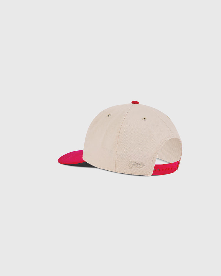 The Ebbets Field Hawaii Islanders 1965 Logo A-Frame Cotton Twill Ballcap in beige features a red brim and adjustable strap, shown from the back on a plain white background.