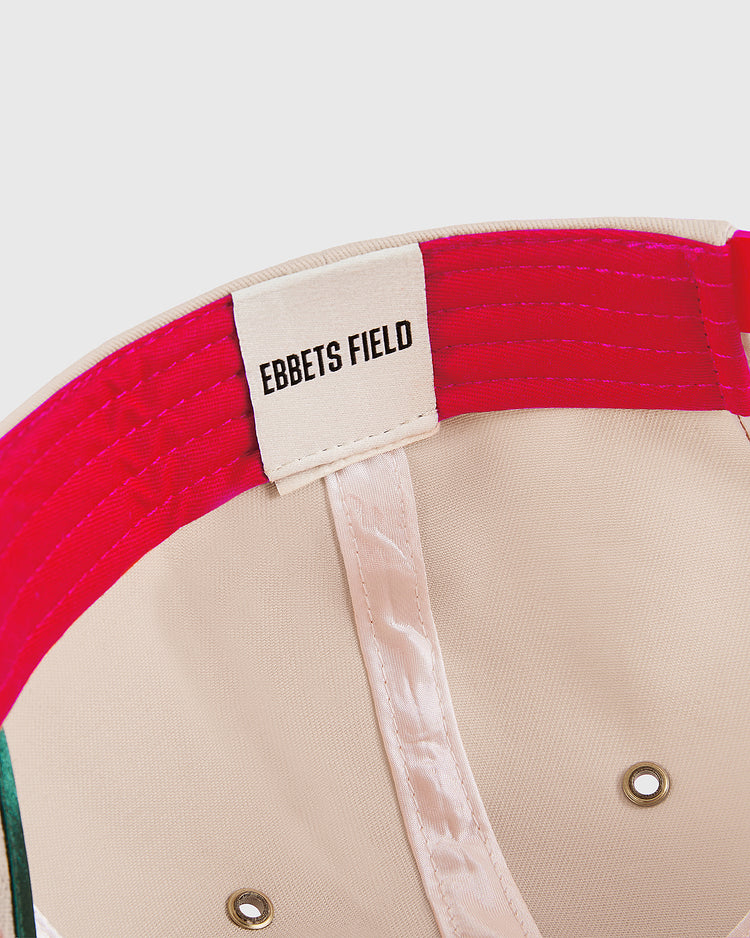 Close-up of the Hawaii Islanders 1965 Logo A-Frame Cotton Twill Ballcap interior, featuring a white Ebbets Field label stitched onto the red inner band. The inside is beige with visible seams and metal eyelets.