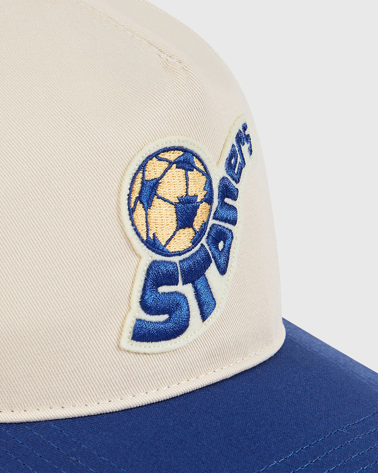 Close-up of the Ebbets Field Pennsylvania Stoners A-Frame Cotton Twill Ballcap in beige and blue, featuring an embroidered soccer ball and 