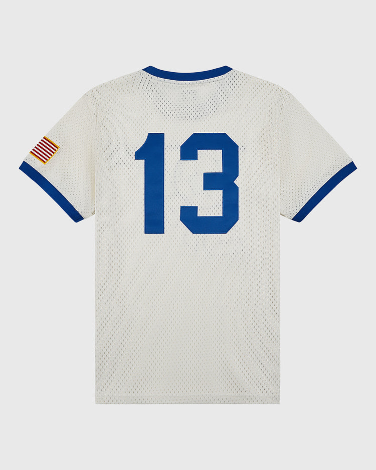 The Ebbets Field Pennsylvania Stoners Mesh Soccer Jersey is a white mesh top with blue trim, featuring a bold blue number 13 on the back and an American flag patch on the left sleeve, inspired by the legendary ASL champions.