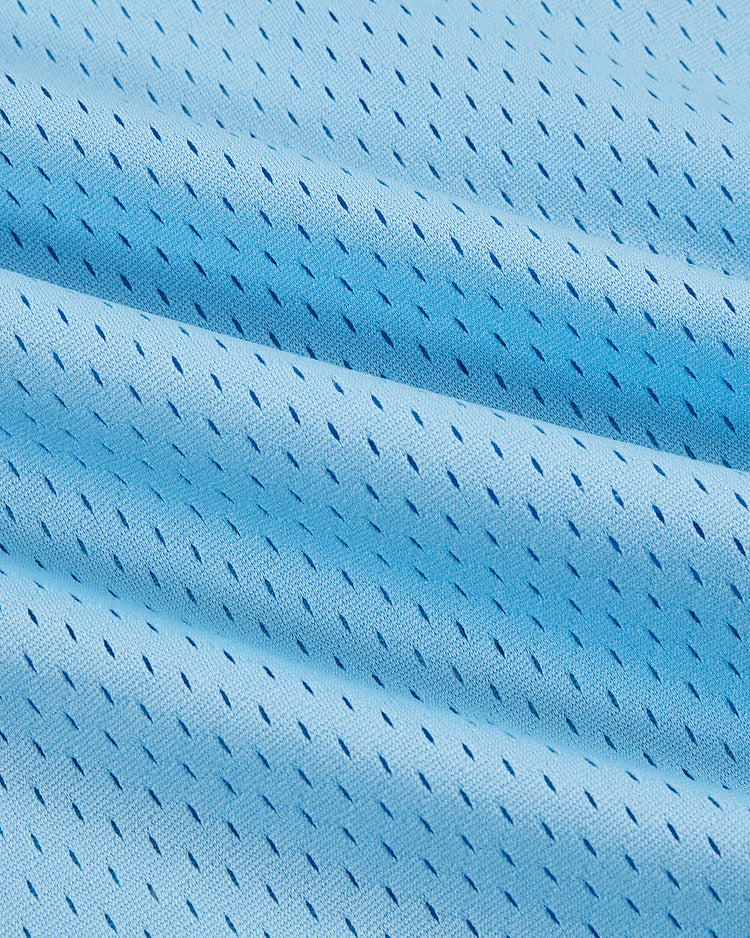 Close-up of the Chicago Cats Mesh Soccer Jersey by Ebbets Field, featuring light blue fine mesh with small, evenly spaced perforations, soft folds, and a subtly wavy surface.