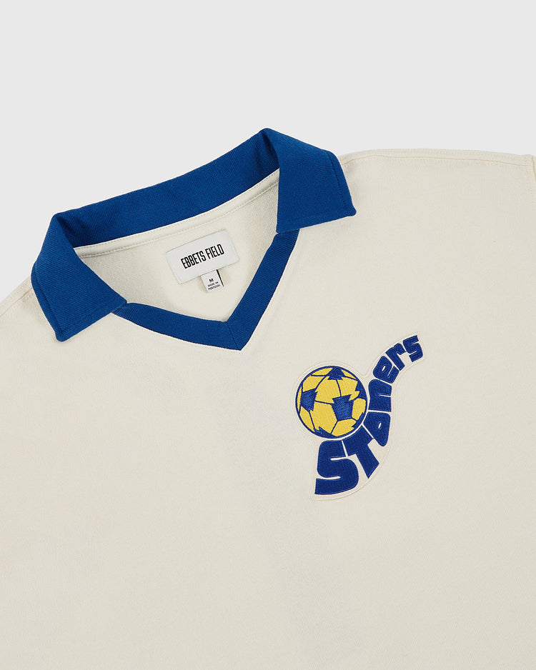The Pennsylvania Stoner Vintage Soccer Goalie Jersey by Ebbets Field features a cream color, blue collar, yellow and blue soccer ball logo, and bold 