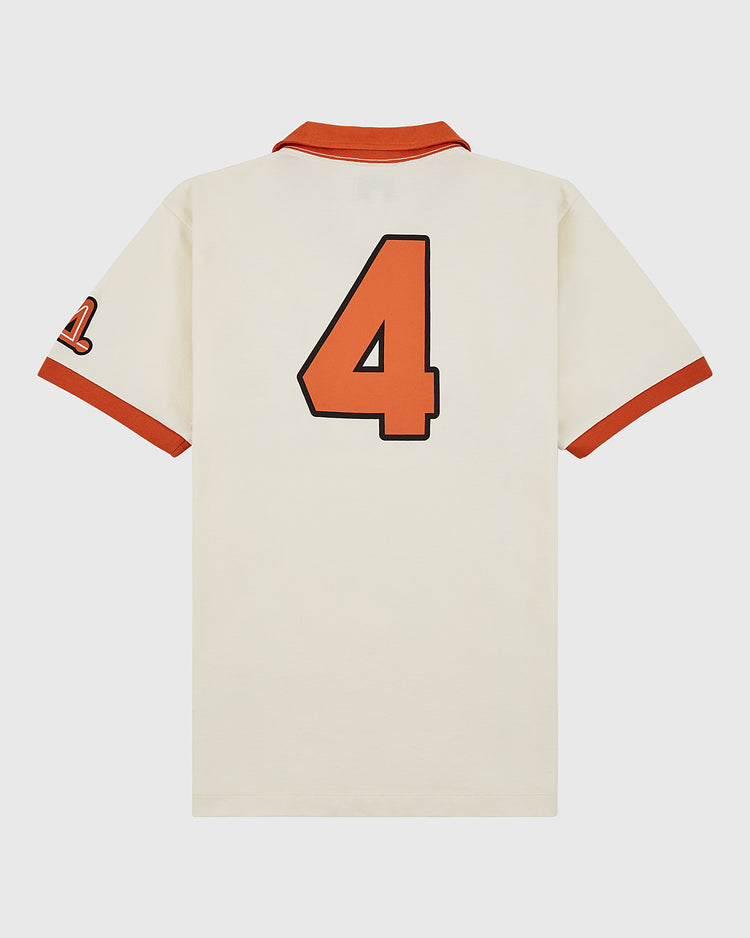 The Ebbets Field Los Angeles Aztecs Vintage Collar Soccer Jersey is a cream cotton polo with orange trim, a bold black-outlined number 4 on the back, and the Aztecs’ number 21 on the left sleeve.